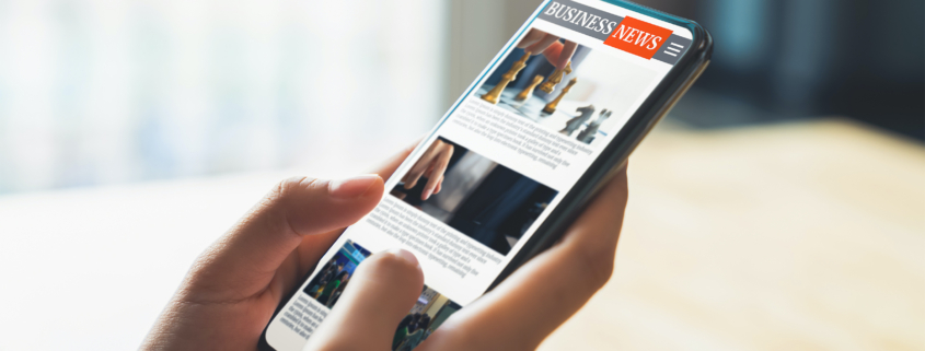 Business man reading placed editorial on mobile device