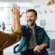 Two business people celebrating the success of outsourced B2B marketing with a high five